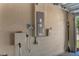 Garage wall featuring electrical panels, a sprinkler system control, and utility connections at 13910 Chalk Hill Pl, Riverview, FL 33579