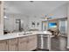 Bright kitchen features stainless steel appliances, white countertops, and an open layout at 13910 Chalk Hill Pl, Riverview, FL 33579