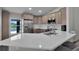 Bright and spacious kitchen featuring stainless steel appliances, white countertops and cabinetry, and sink with water view at 13910 Chalk Hill Pl, Riverview, FL 33579