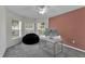 Well-lit office space with multiple windows, a modern desk, and comfortable seating at 13910 Chalk Hill Pl, Riverview, FL 33579