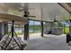 Relaxing screened patio with waterfront views, featuring a hot tub and comfortable seating at 13910 Chalk Hill Pl, Riverview, FL 33579