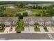 An aerial view shows the community townhomes in a landscaped neighborhood with a water feature at 1395 White Fox Run, Lutz, FL 33549