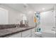 Bright bathroom features granite countertops, white cabinets, and shower-tub combination at 1395 White Fox Run, Lutz, FL 33549