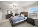 This spacious bedroom features a large window for natural light and a ceiling fan for added comfort at 1395 White Fox Run, Lutz, FL 33549