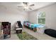 Cozy bedroom features a bright window, ceiling fan, and comfortable sleeping space at 1395 White Fox Run, Lutz, FL 33549