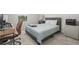 Comfortable bedroom features a light blue bedspread, desk area, and soft natural light at 1395 White Fox Run, Lutz, FL 33549
