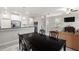 This dining area offers a modern table and seating, conveniently located next to the kitchen and living area at 1395 White Fox Run, Lutz, FL 33549