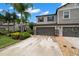Inviting townhome featuring a spacious two-car garage and well-maintained landscaping at 1395 White Fox Run, Lutz, FL 33549