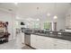 A modern kitchen features a breakfast bar and is open to the living areas for easy entertaining at 1395 White Fox Run, Lutz, FL 33549
