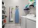 The laundry room is equipped with a washer, dryer, and shelving for storage at 1395 White Fox Run, Lutz, FL 33549