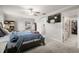 Spacious main bedroom features a tv, ceiling fan, and ensuite bathroom with large walk-in closet at 1395 White Fox Run, Lutz, FL 33549