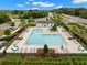 Community pool with lounge chairs and umbrellas offers residents a relaxing outdoor space at 1395 White Fox Run, Lutz, FL 33549