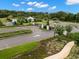 This street view shows a gated entry of a community with well-manicured landscaping at 1395 White Fox Run, Lutz, FL 33549