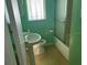 Cozy bathroom with a shower-tub combo and a pedestal sink at 15034 Lake Magdalene Blvd, Tampa, FL 33618