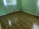Neutral-toned bedroom featuring laminate wood flooring and a large window at 15034 Lake Magdalene Blvd, Tampa, FL 33618