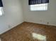 Modest bedroom featuring durable laminate wood flooring and a window at 15034 Lake Magdalene Blvd, Tampa, FL 33618