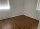 Cozy bedroom featuring durable laminate wood flooring and a large window at 15034 Lake Magdalene Blvd, Tampa, FL 33618