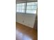 Bright room featuring durable laminate wood flooring and a large window with a view at 15034 Lake Magdalene Blvd, Tampa, FL 33618