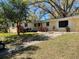 Single-story home with large window and mature landscaping at 15034 Lake Magdalene Blvd, Tampa, FL 33618