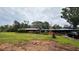 Exterior of home with a spacious yard and a dark vehicle in the driveway at 19036 Blake Rd, Odessa, FL 33556
