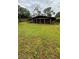 Back of house featuring a large screened-in porch for enjoying outdoor living at 19036 Blake Rd, Odessa, FL 33556