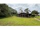 Back of house featuring a large screened-in porch for enjoying outdoor living at 19036 Blake Rd, Odessa, FL 33556