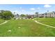 Expansive green space within the community, featuring walkways, landscaping, and a view of the pool area at 213 Fernwood Cir # 213, Seminole, FL 33777