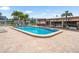 Inviting community pool area with lounge chairs, shade, and a poolside clubhouse at 213 Fernwood Cir # 213, Seminole, FL 33777