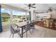 Bright eat-in dining room with modern furnishings and a large bank of windows overlooking the grounds at 213 Fernwood Cir # 213, Seminole, FL 33777