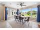 Bright eat-in dining room with modern furnishings and a large bank of windows overlooking the grounds at 213 Fernwood Cir # 213, Seminole, FL 33777