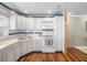 Bright kitchen with white appliances, custom cabinets, and wood floor at 213 Fernwood Cir # 213, Seminole, FL 33777