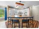 Eat-in kitchen with breakfast bar, custom lighting, and white appliances at 213 Fernwood Cir # 213, Seminole, FL 33777