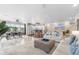 Bright, open-concept living room with tile floors, comfy furnishings, and eat-in kitchen with breakfast bar at 213 Fernwood Cir # 213, Seminole, FL 33777