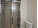 Bathroom featuring toilet, shower, grab bar, glass door, and tiled walls at 2333 Feather Sound Dr # A401, Clearwater, FL 33762