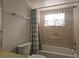 Bathroom featuring a shower-tub combo and a large window at 2333 Feather Sound Dr # A401, Clearwater, FL 33762