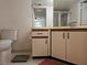 Bathroom featuring toilet, sink, vanity, cabinets, and shower with glass doors at 2333 Feather Sound Dr # A401, Clearwater, FL 33762
