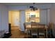 Dining area with hardwood floors, chandelier, and view into the kitchen at 2333 Feather Sound Dr # A401, Clearwater, FL 33762