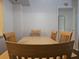 Spacious dining area with wood table and chairs, with natural light and minimal decor at 2333 Feather Sound Dr # A401, Clearwater, FL 33762