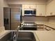 Well-lit kitchen featuring white cabinets, countertops and stainless steel appliances at 2333 Feather Sound Dr # A401, Clearwater, FL 33762