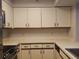 Kitchen boasts white cabinets and countertops, complemented by stainless steel appliances at 2333 Feather Sound Dr # A401, Clearwater, FL 33762