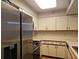 Bright kitchen features white cabinets, countertops and stainless steel appliances at 2333 Feather Sound Dr # A401, Clearwater, FL 33762