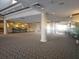 Spacious lobby area featuring decorative lighting, columns, carpeted flooring, and seating areas at 2333 Feather Sound Dr # A401, Clearwater, FL 33762