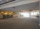 Large open lobby area with decorative lighting, columns, carpeted flooring, and ample space at 2333 Feather Sound Dr # A401, Clearwater, FL 33762
