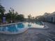 Outdoor swimming pool surrounded by comfortable sun loungers and tropical foliage at 2333 Feather Sound Dr # A401, Clearwater, FL 33762