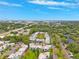 This is an aerial photo of the community surrounded by lush greenery, showcasing the city beyond at 2834 Somerset Park Dr, Tampa, FL 33613