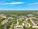An aerial view of the community surrounded by lush greenery and clear blue skies at 2834 Somerset Park Dr, Tampa, FL 33613