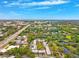 Expansive aerial view showcasing community, nearby trees, and the broader cityscape at 2834 Somerset Park Dr, Tampa, FL 33613