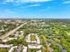 This aerial shot showcases lush greenery, buildings, parking, and views of the city beyond at 2834 Somerset Park Dr, Tampa, FL 33613