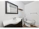 Bathroom featuring a dark vanity, framed mirror, and modern toilet at 2834 Somerset Park Dr, Tampa, FL 33613