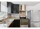 Modern kitchen with stainless steel appliances, granite countertops, and a stylish backsplash at 2834 Somerset Park Dr, Tampa, FL 33613